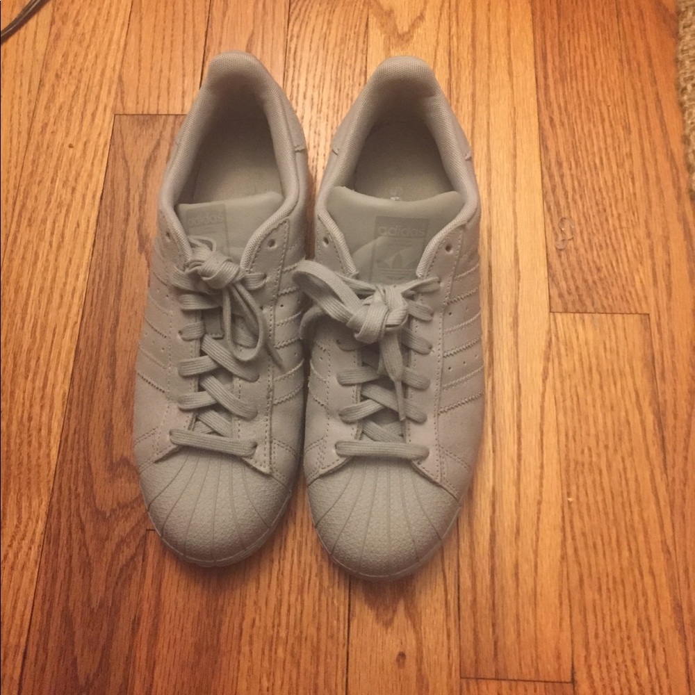 Gray and silver adidas superstars