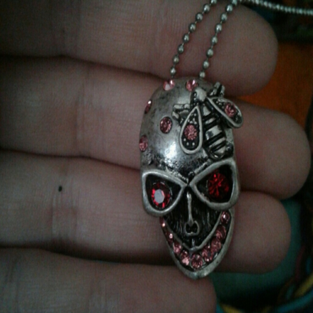 A pink jeweled skull necklace