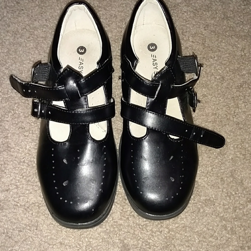 Black pair  of shoes for a little girl.