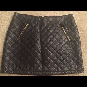 Black, leather mini-skirt with gold zipper details