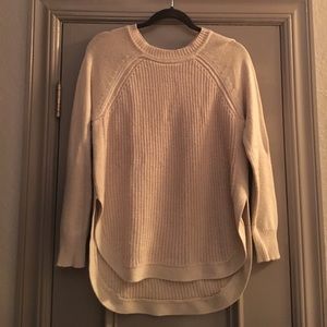 Cream colored sweater.