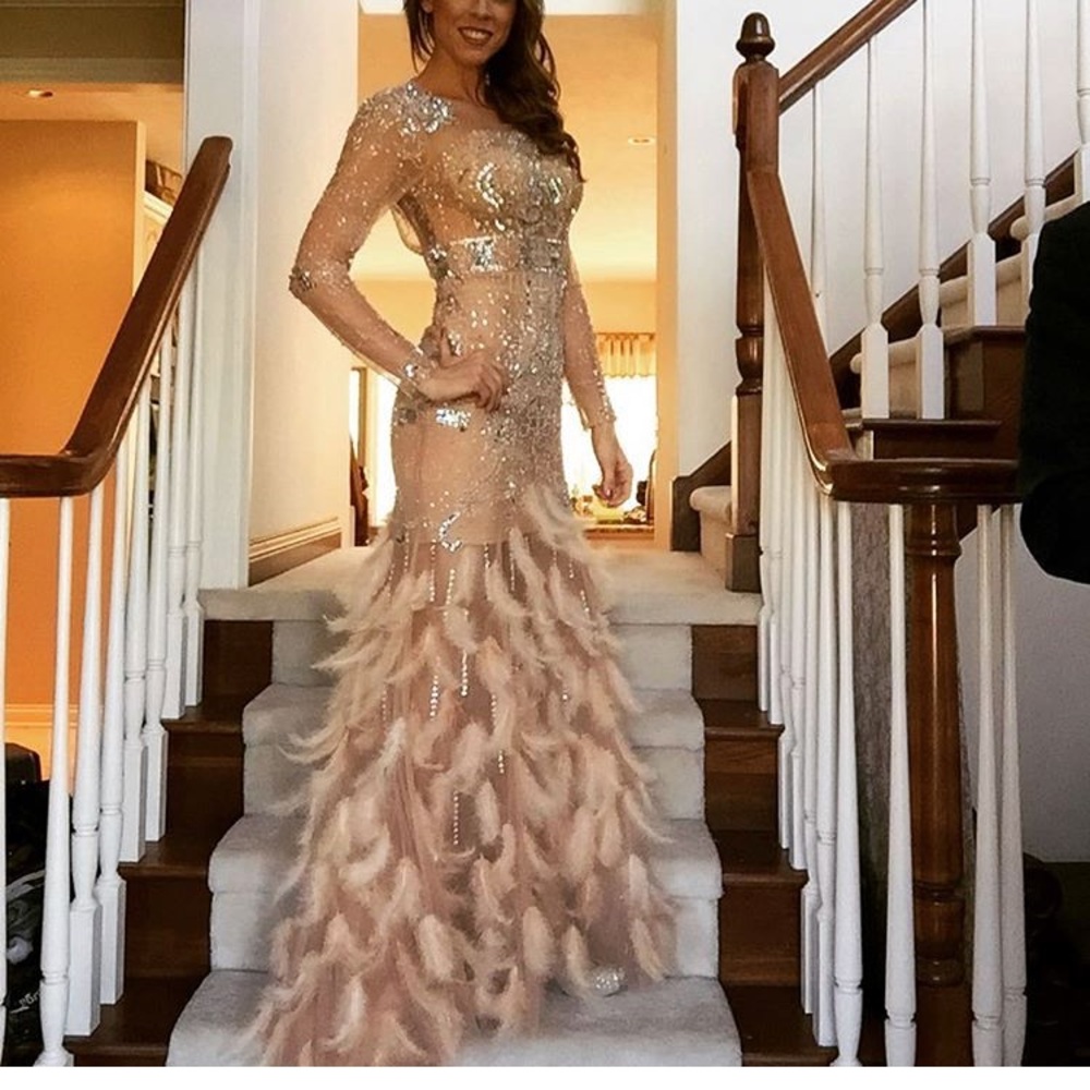 Stunning beaded and feathered gown.