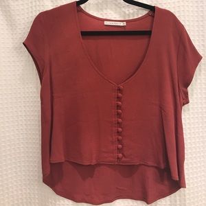 Flynn Skye-  burnt orange top.