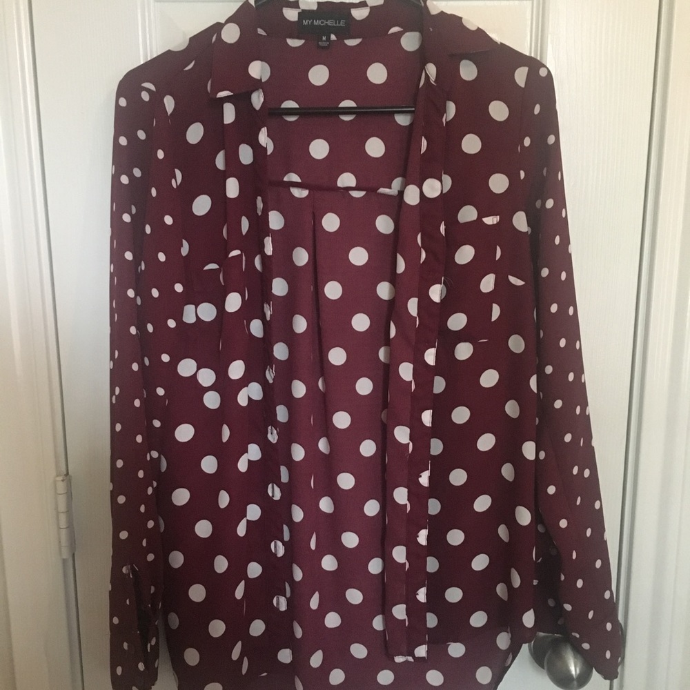 Maroon long sleeve blouse with white polka dots.