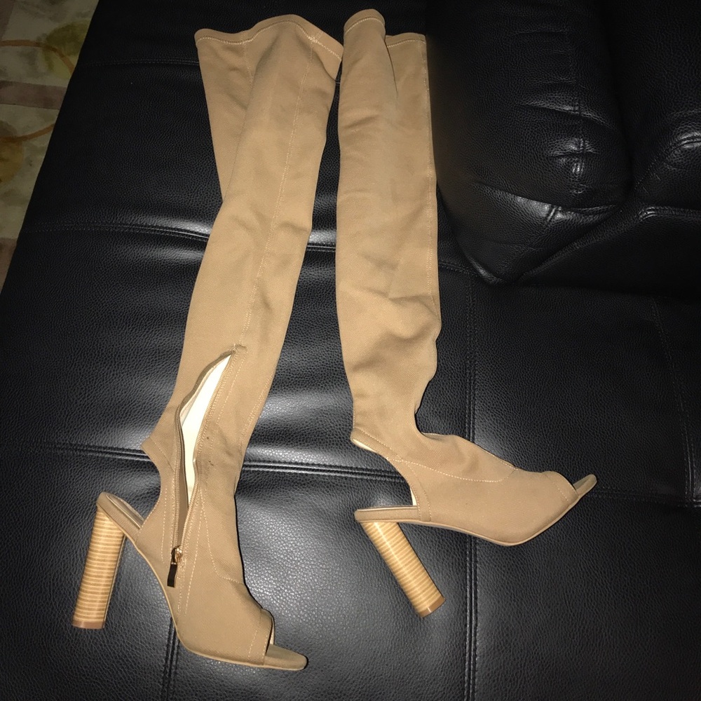Thigh high peep toe heels.