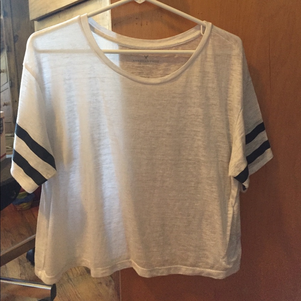 White shirt with black stripes on sleeve