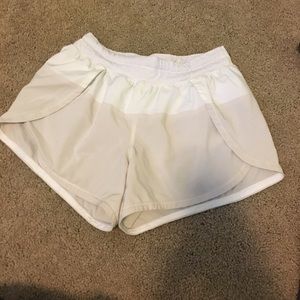 Tan running shorts. Split on the side