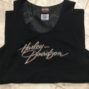 Black ribbed tank top with skull cutout.