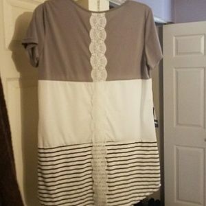 Tunic with lace trim down the back.