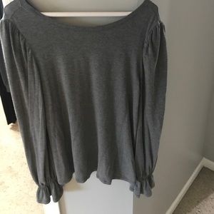 Grey long sleeve shirt with ruffled bottom sleeve.