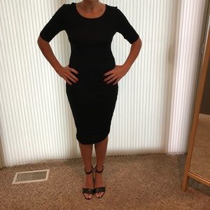 Black dress with cinched side detail.