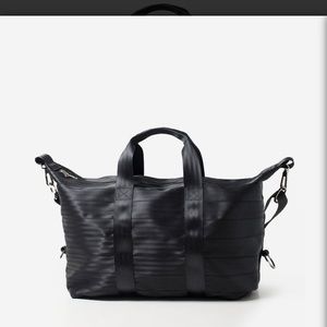 Harvey's black seatbelt weekender bag.