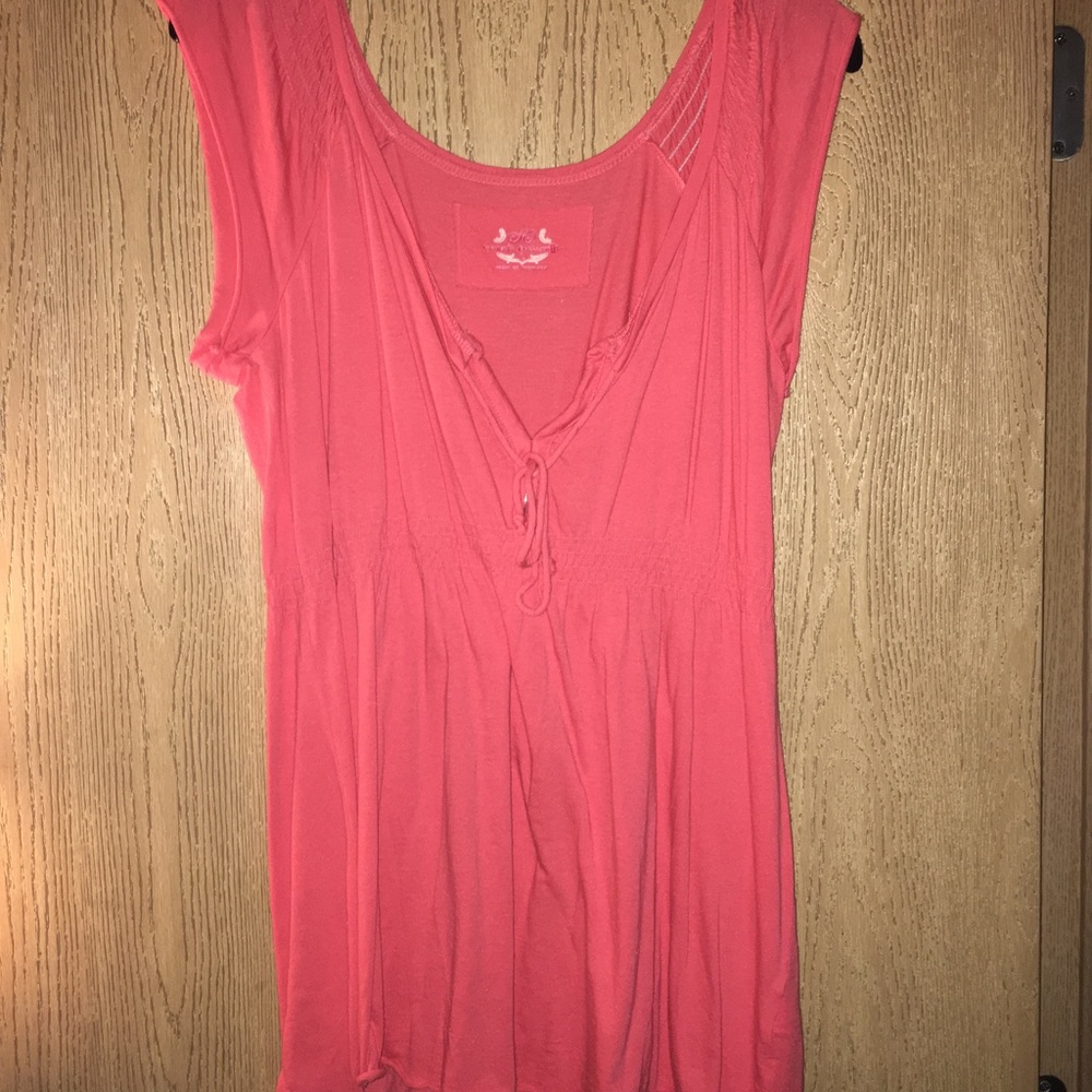 Pinkish-orange V cut top.
