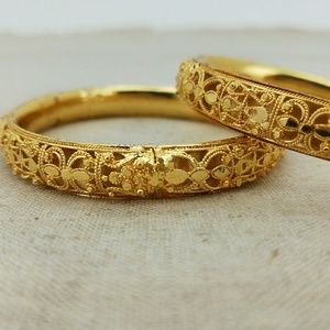 Gold bangles with intricate design
