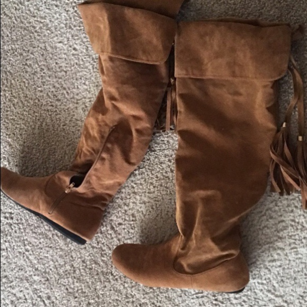 Pair of brown suede quarter-zip fringe jackboots