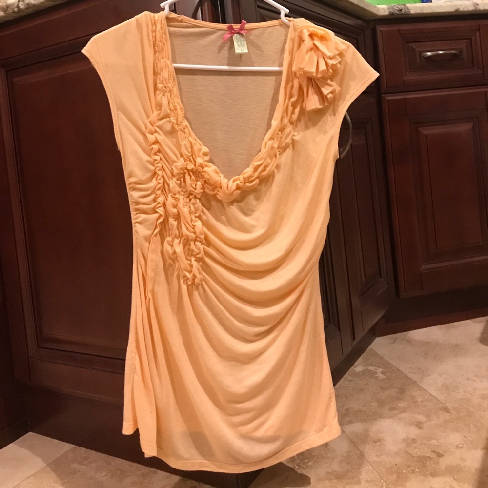 A peach embellished top.