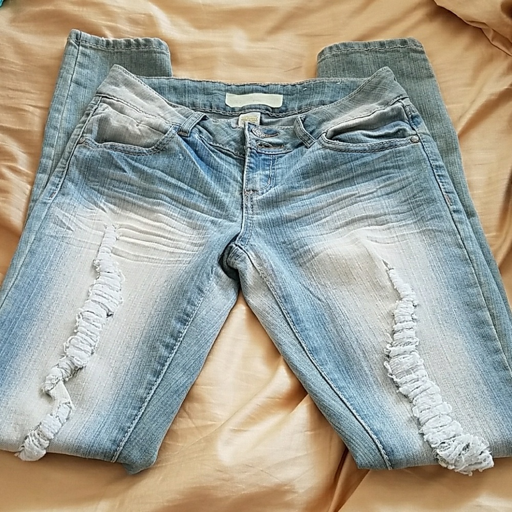 Distressed light wash jeans.