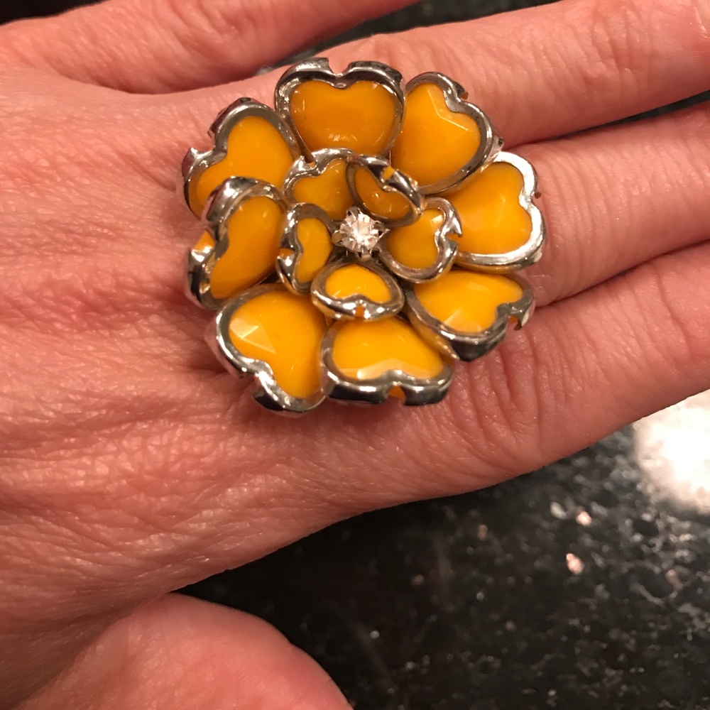 Yellow floral ring with silver trimmings.