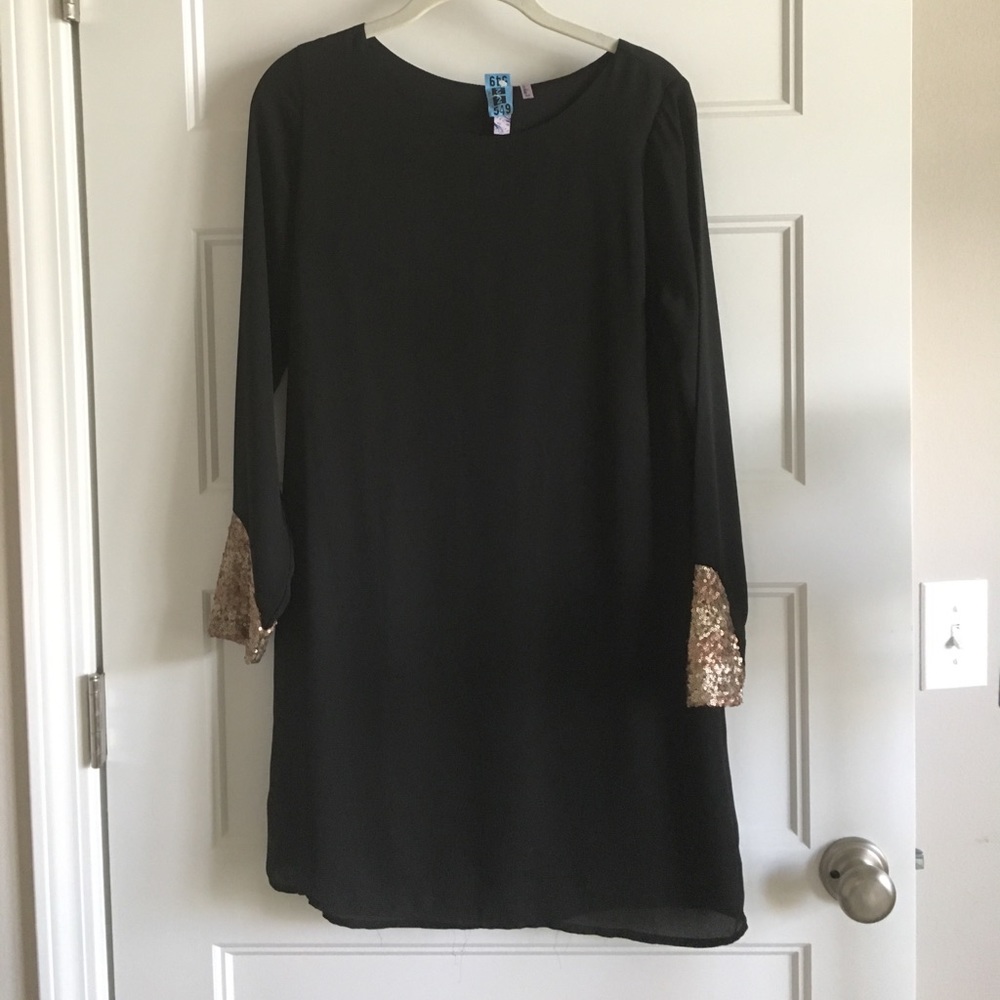 Black swing dress with sequin cuffs