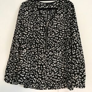 A black & white blouse with zipper