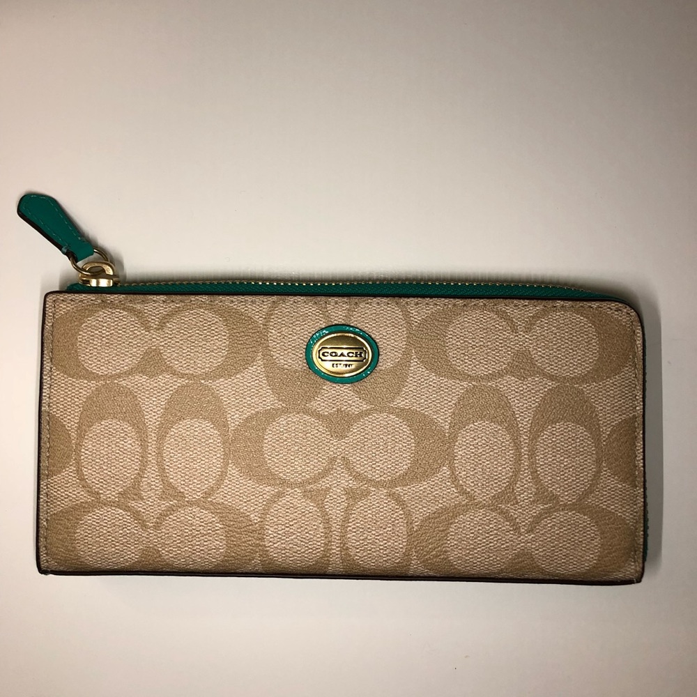 Coach signature wallet w/ teal trim and interior.