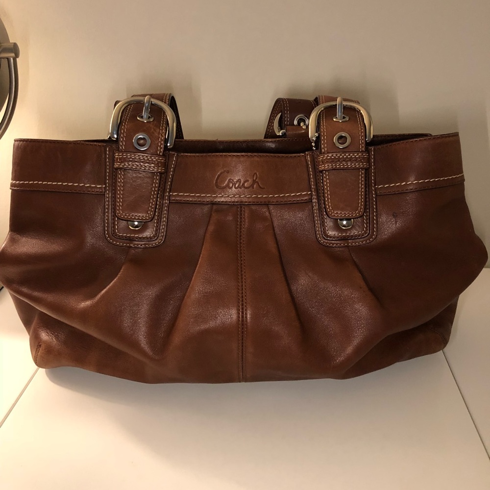 Brown leather coach shoulder bag.