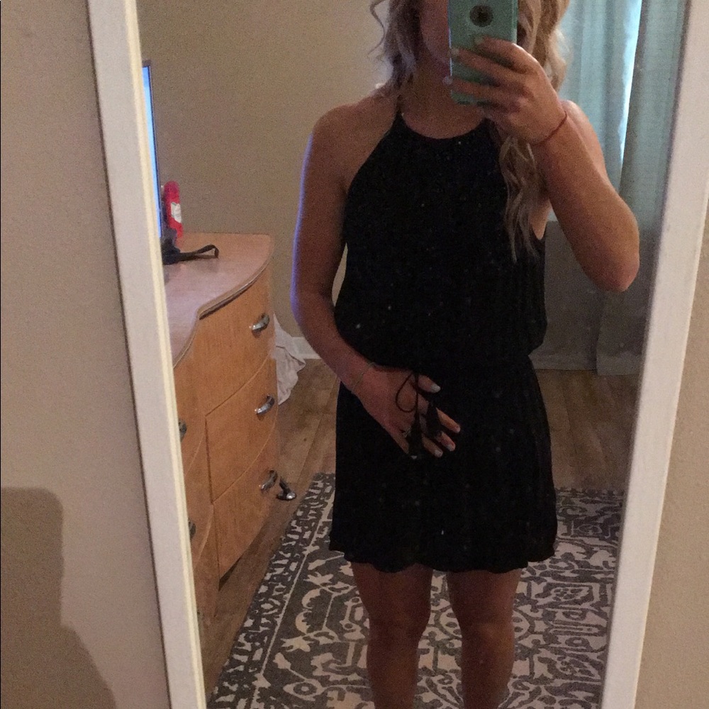 Black romper with tassel tie at waist