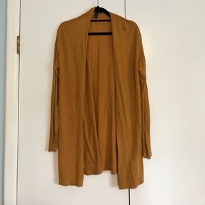 A long mustard yellow cardigan
