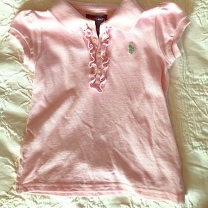 Perfect pink top with slight ruffles at buttons