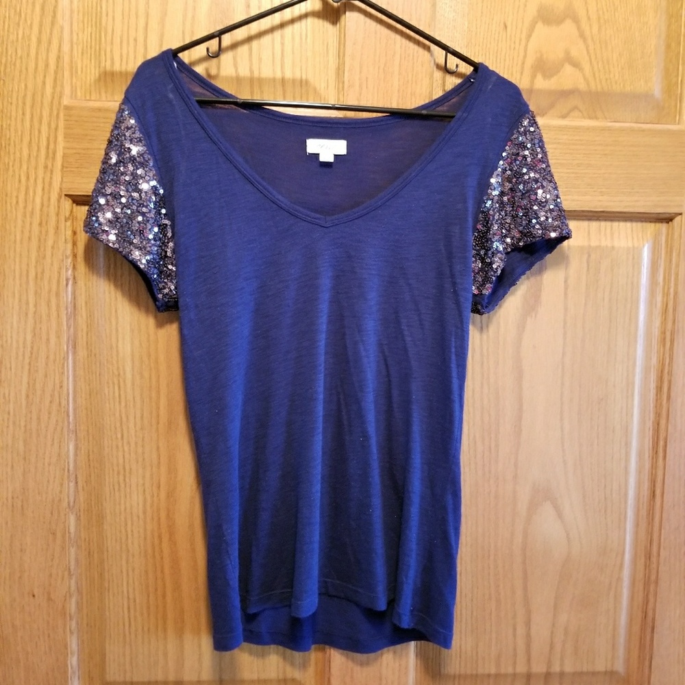Navy blue shirt with sparkly sleeves.