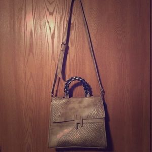 Golden brown leather tote with shoulder strip.