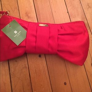 Adorable ruby red Kate Spade clutch. NEVER USED