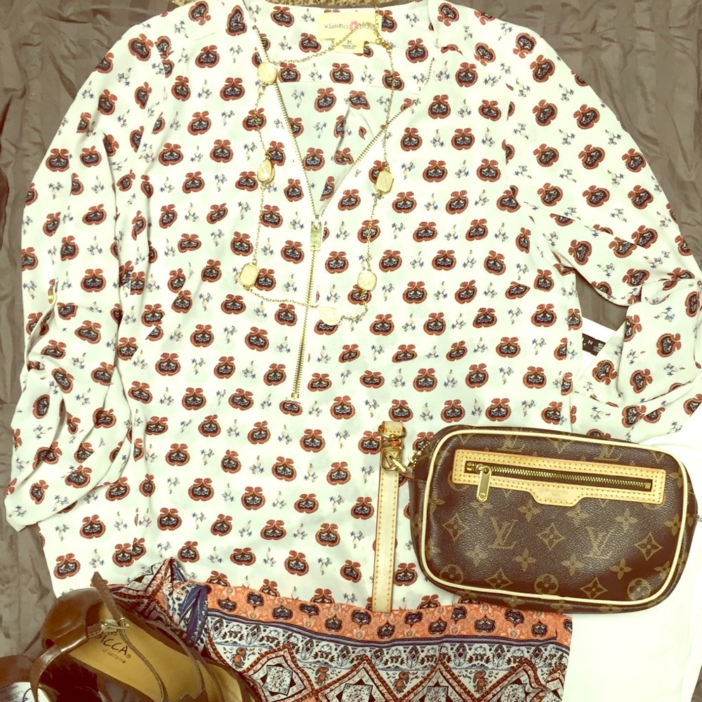 Cute cream colored blouse with cool print.