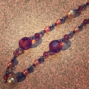 Bronze-colored, beaded necklace.