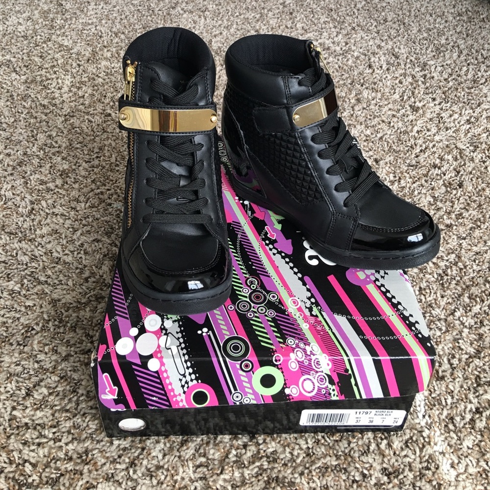 Black wedge sneakers with gold accents