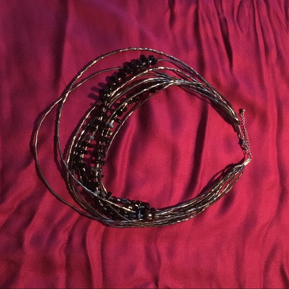 Multi strand black beaded necklace.