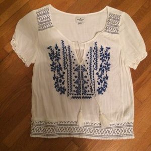 white top with blue embroidery