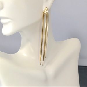 Gold colored dangling stream earrings