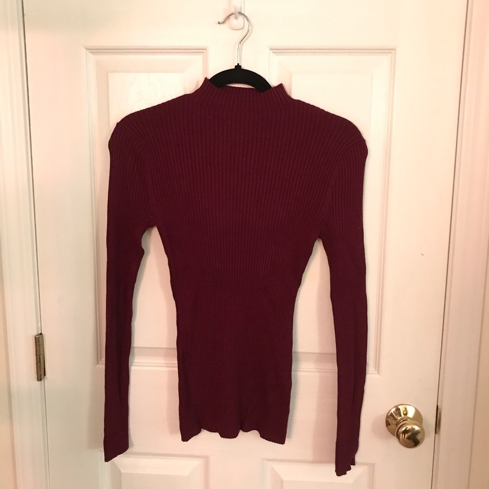 Form fitting long sleeve sweater.