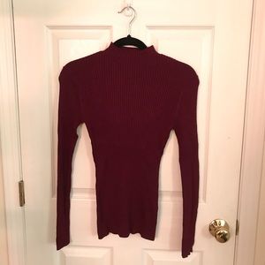 Form fitting long sleeve sweater.