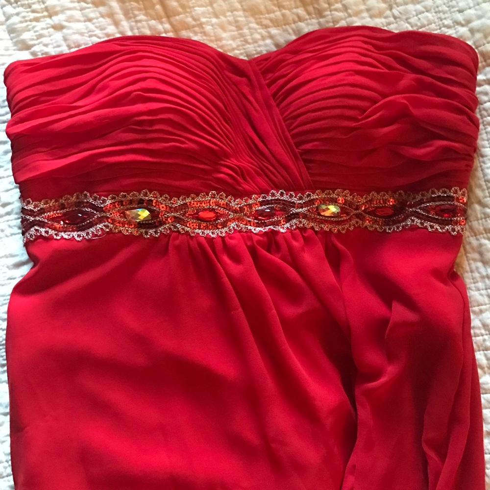 Red strapless gown with sequin detail.