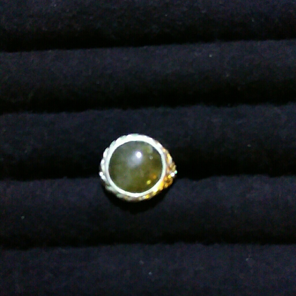 Green stone in silvertone ring