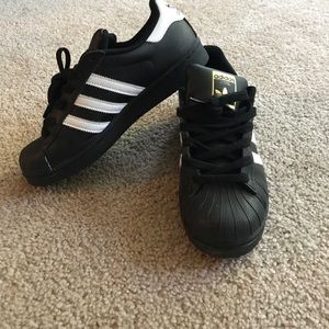 Black and white adidas superstars
