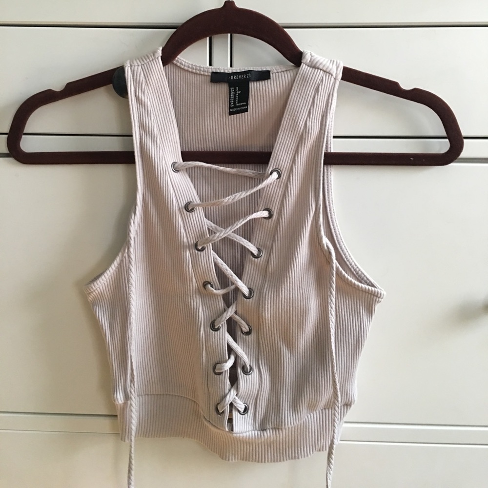 Small tan crop top with cross cross design.