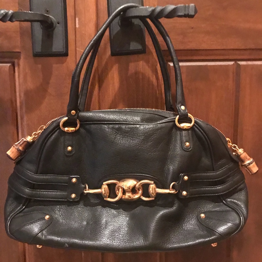 Gucci black handbag with wooden zipper pulls.