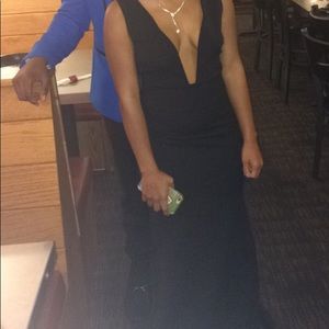 A black fitted dress , it does stretch