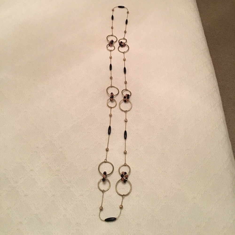 Gold tone/resin 46” length necklace. Never worn