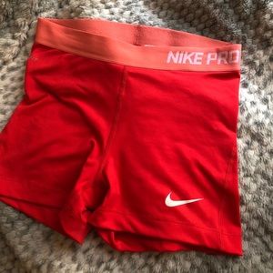 Coral orange Nike Pro athletic shorts