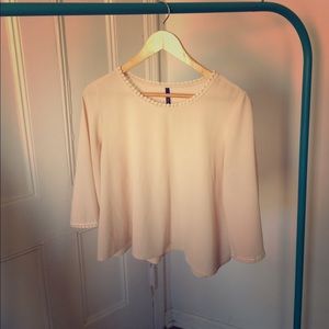 Silky, cream colored blouse.
