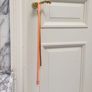 J. Crew thin neon orange belt with gold hardware.